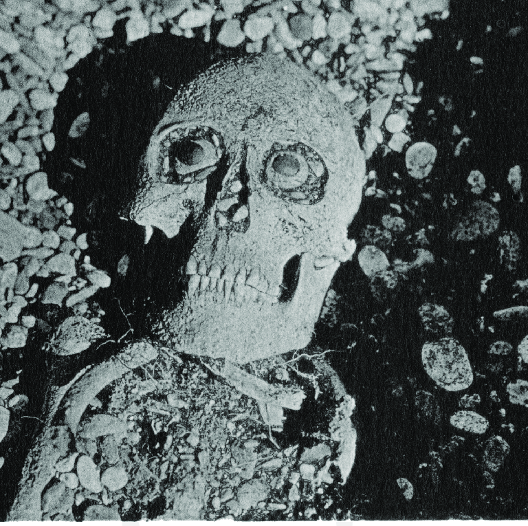 Close up photograph of Ipiutak Burial 51 showing the inlaid ivory eyes within the